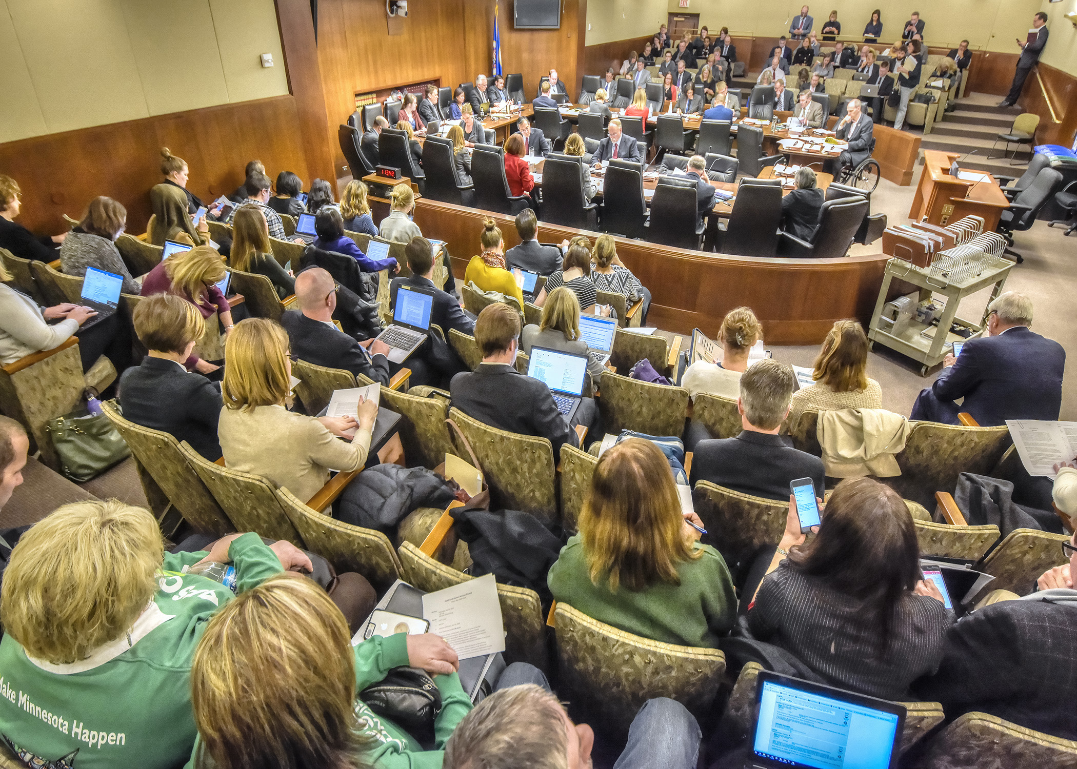 Almost all seats in a State Office Building hearing room were filled April 18 while the House Health and Human Services Finance Committee walks through its potential omnibus bill. Photo by Andrew VonBank